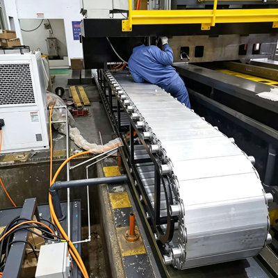 Large scale metal conveyor drag chain system in industrial manufacturing plant
