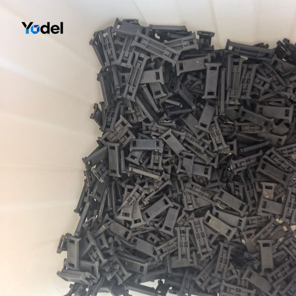 Molded 7x7mm small drag chain individual links collected in bin before assembly