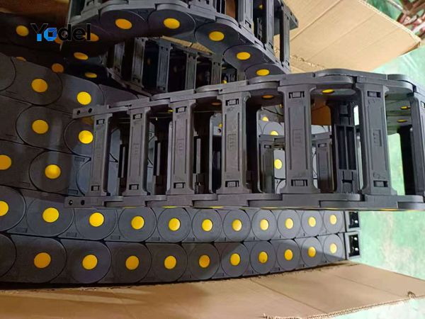 Assembled bridge style cable drag chain 55x100 neatly coiled inside export cardboard box