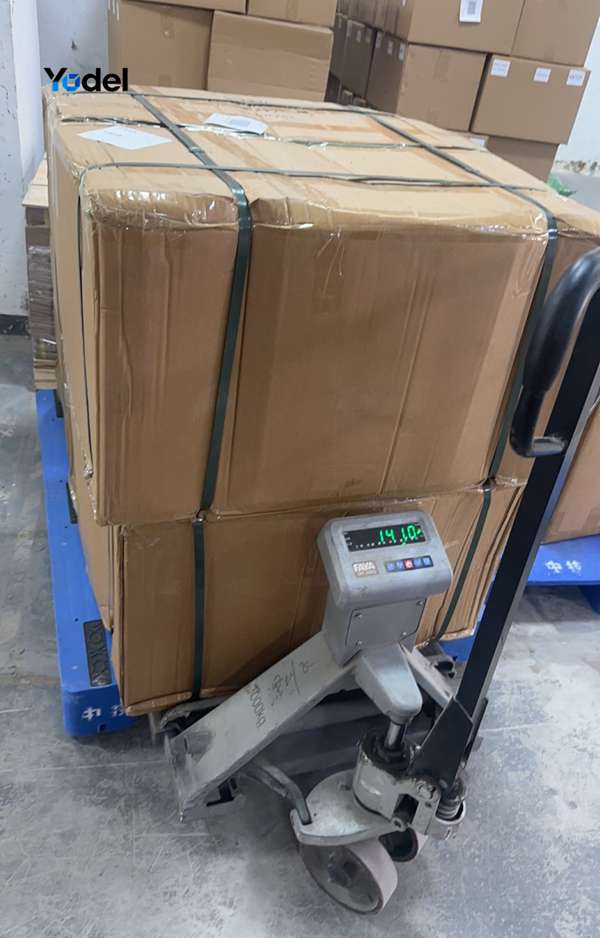 Quality control team weighing packaged drag chain 25x38 cartons on digital scale before export shipping