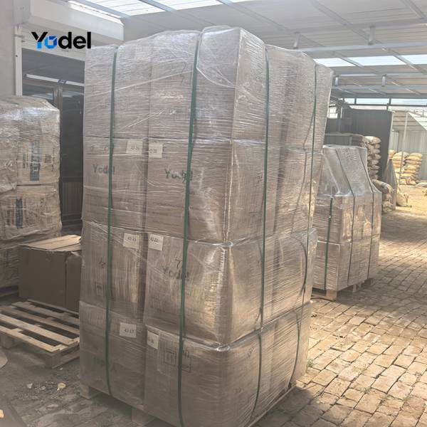 High stack of film wrapped corrugated cartons containing drag chain 45x100 strapped on wooden pallet for dispatch