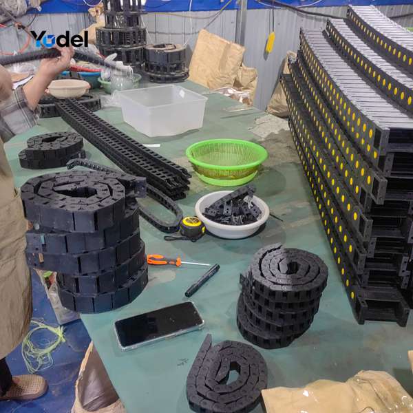 Skilled workers at cable drag chain suppliers assembling 15x25 silent cable carriers