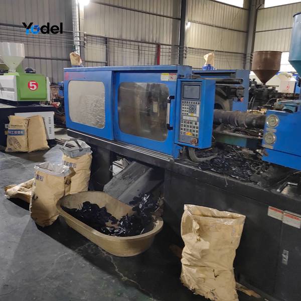Industrial injection molding machine producing PA66 25x103 flexible cable carrier links in factory