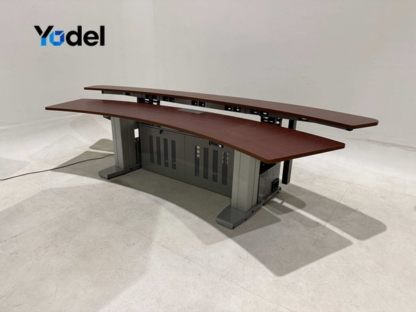 S-shape flexible cable carrier 25x103 installed under control room monitoring table for desk cable management