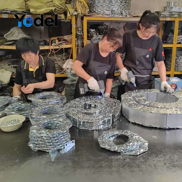 Workers Assembling Steel Drag Chain Components in Factory