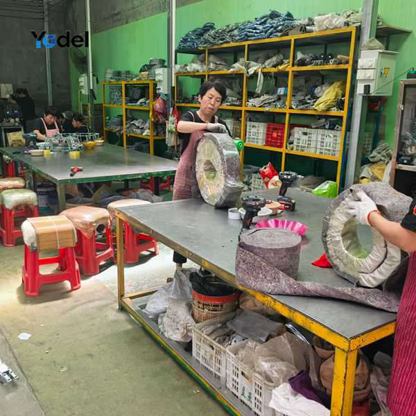 Factory workers assembling customized internal dividers and perforated crossbeams for TLG75(30/50/100) enclosed drag chain