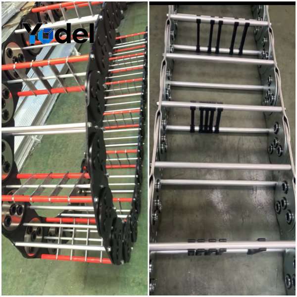 Custom stainless steel cable carriers featuring black oxide drag chains and stainless steel round tube stays with vertical dividers